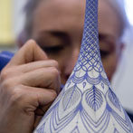 Rhian Malin decorating a mandala bottle in her workshop 2019
